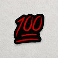 100 Emoji embroidered patch displayed on a light grey felt background.