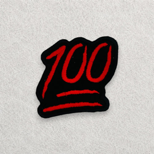 100 Emoji embroidered patch displayed on a light grey felt background.