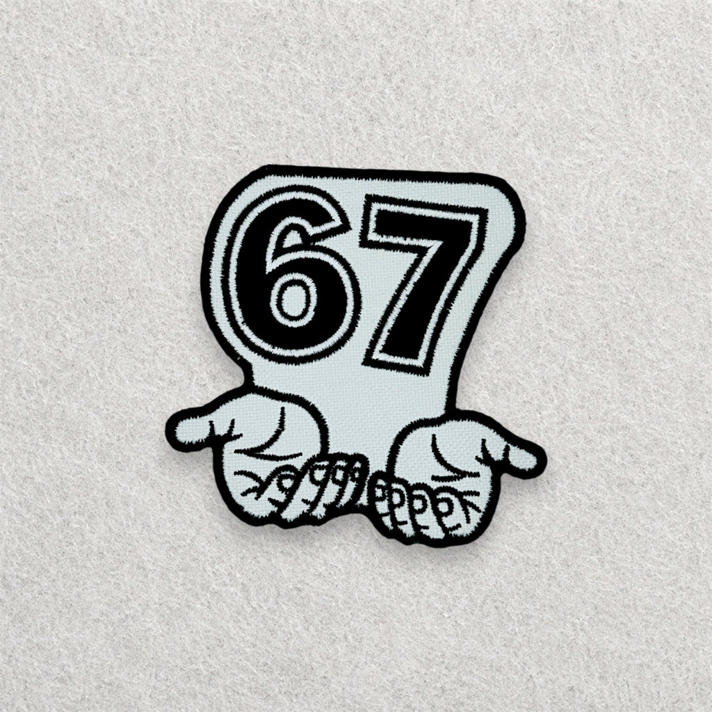 67 embroidered patch displayed on a light grey felt background.