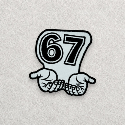 67 embroidered patch displayed on a light grey felt background.