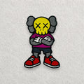 KAWS Companion embroidered patch displayed on a light grey felt background.