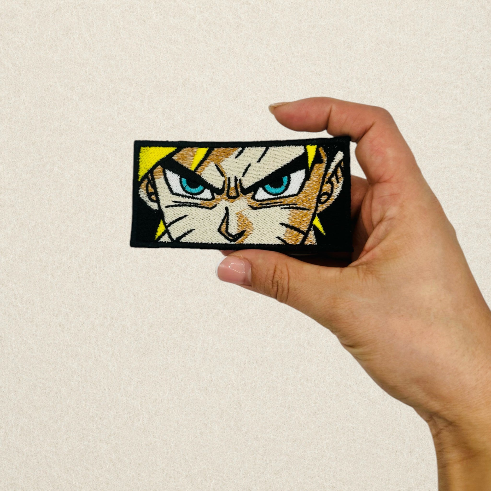 Naruto Uzumaki embroidered patch shown in hand to demonstrate its actual size.