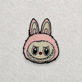 Pink Labubu embroidered patch displayed on a light grey felt background.