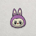 purple Labubu embroidered patch displayed on a light grey felt background.