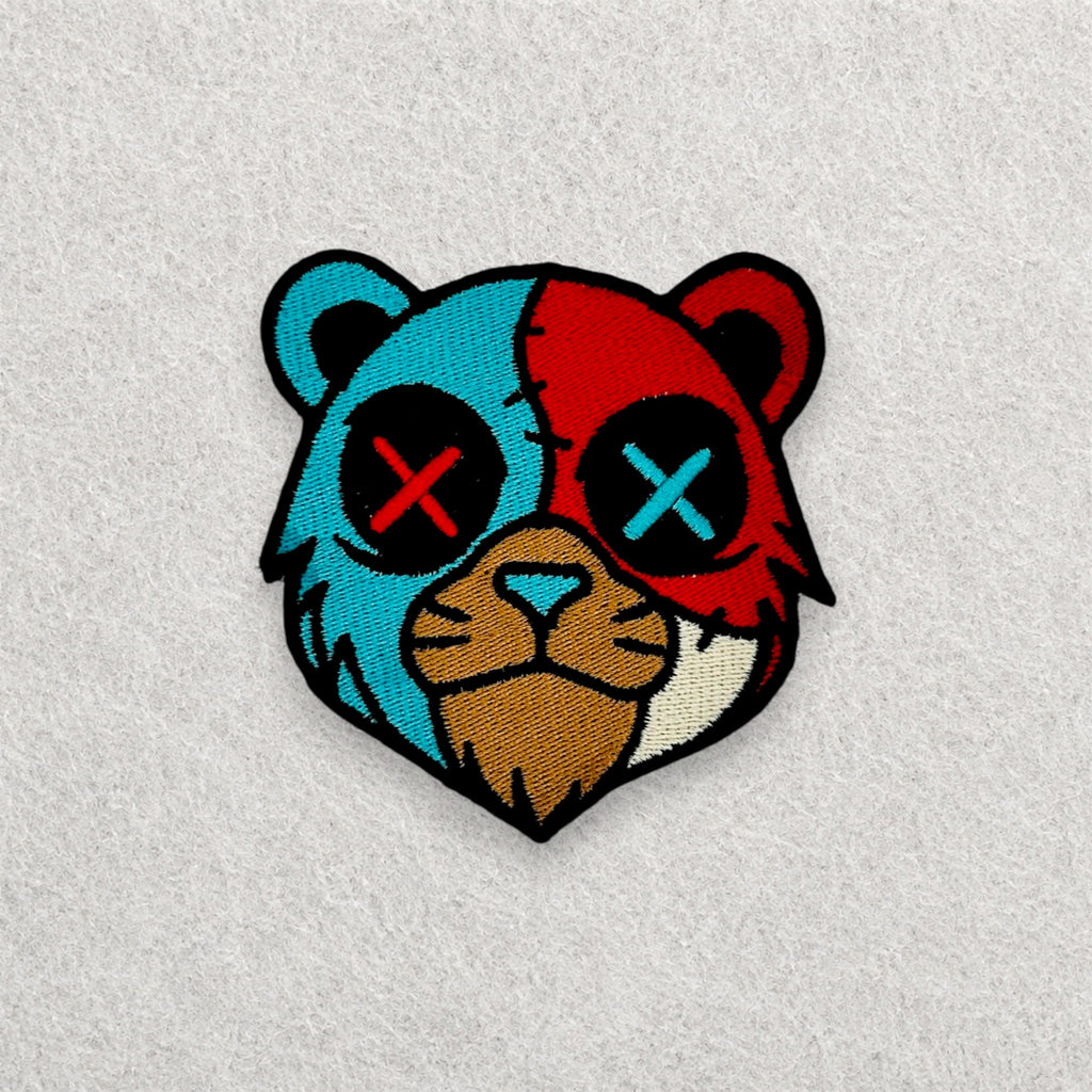 Split Face Bear embroidered patch displayed on a light grey felt background.